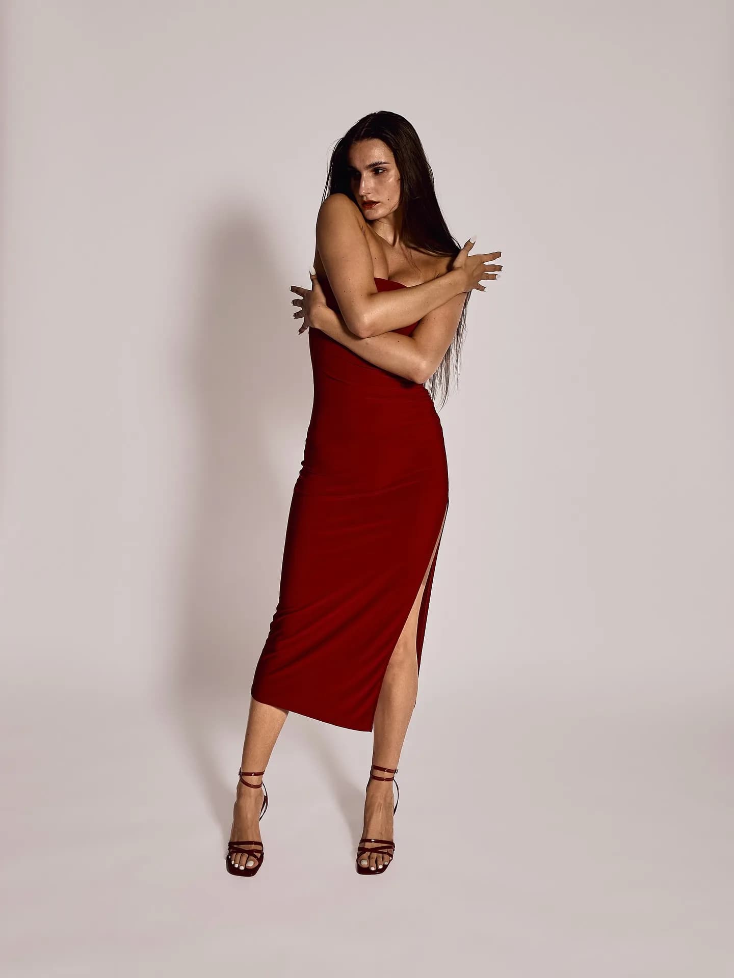 Full-length fashion editorial portrait, red dress