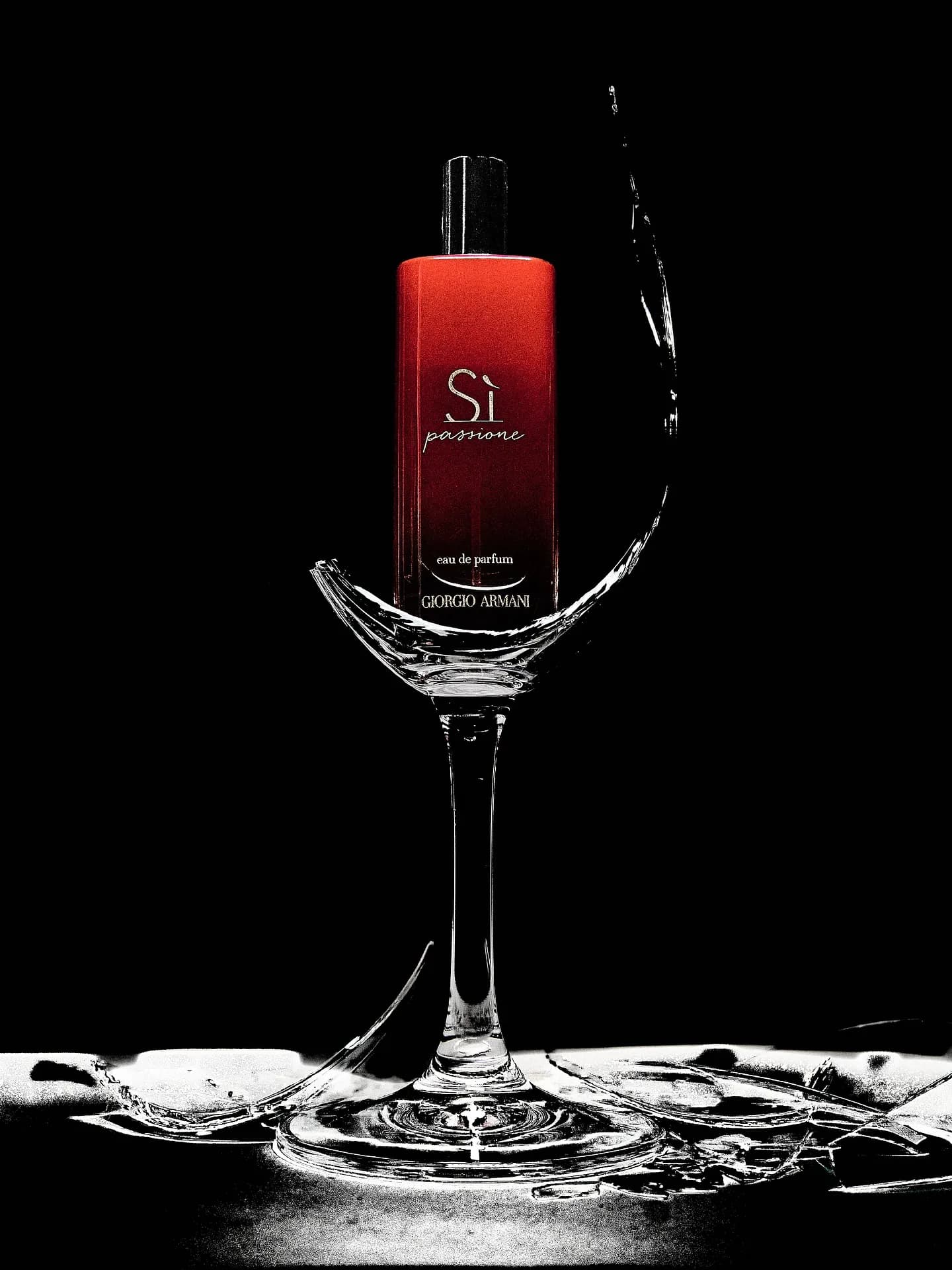 Commercial product photography — a fragrance bottle staged in shattered glass